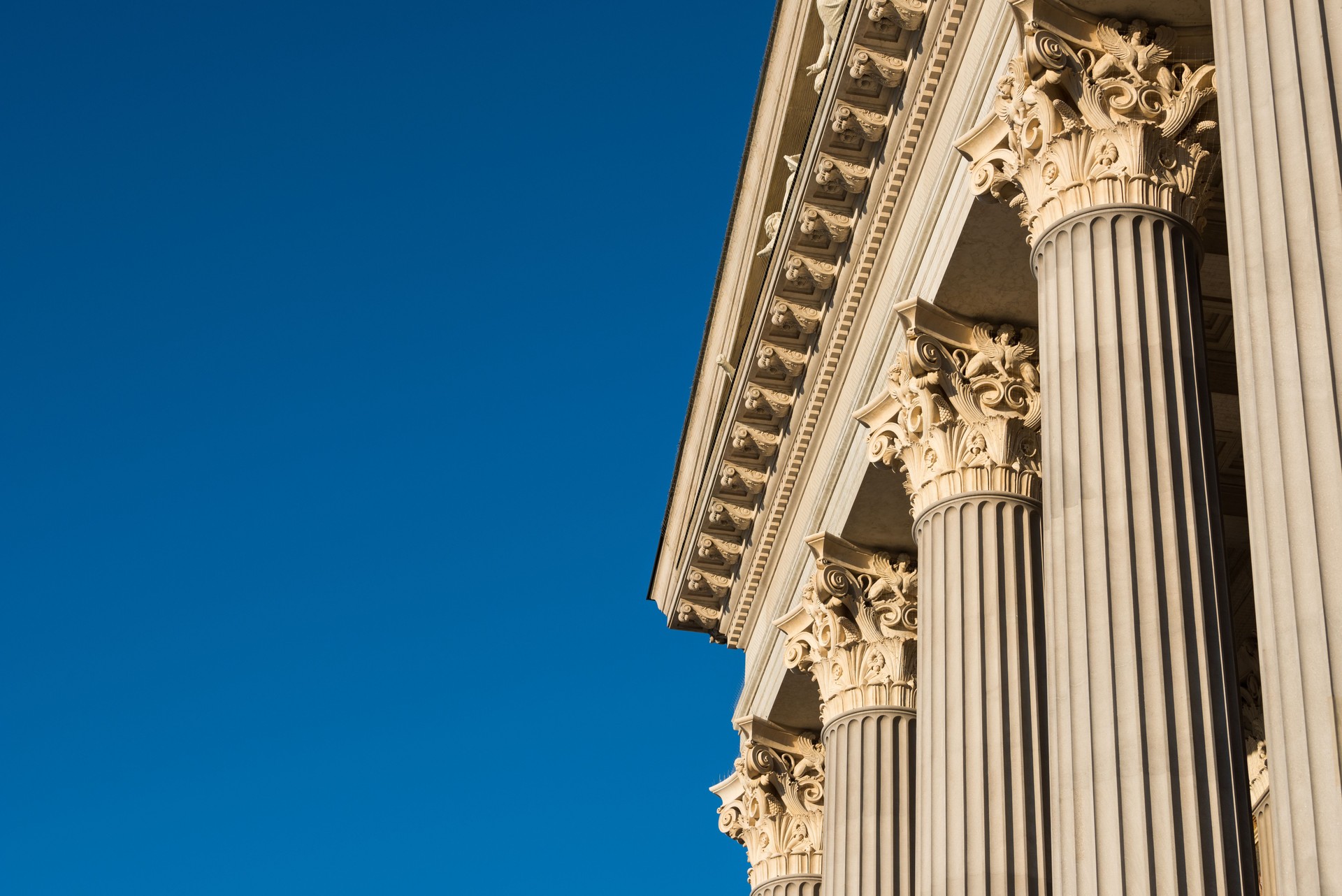 Architectural detail of marble Corinthian order columns with copy space